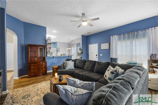 38 Travertine Cir, Savannah, GA 31419 - living area with arched walkways, wood finished floors, a ceiling fan, a textured ceiling, and baseboards