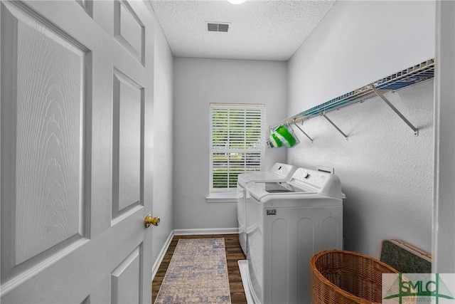 38 Travertine Cir, Savannah, GA 31419 - laundry area with washer and clothes dryer, dark wood finished floors, a textured ceiling, and baseboards