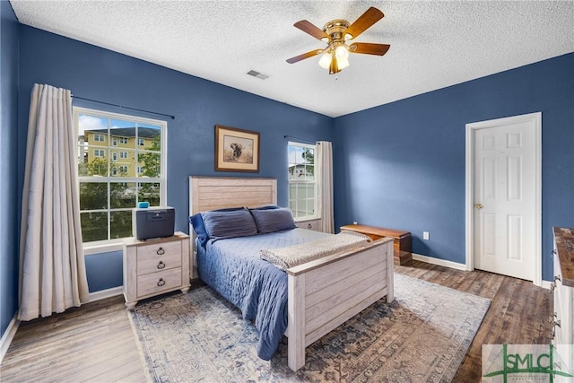 38 Travertine Cir, Savannah, GA 31419 - bedroom featuring a textured ceiling, wood finished floors, baseboards, and ceiling fan