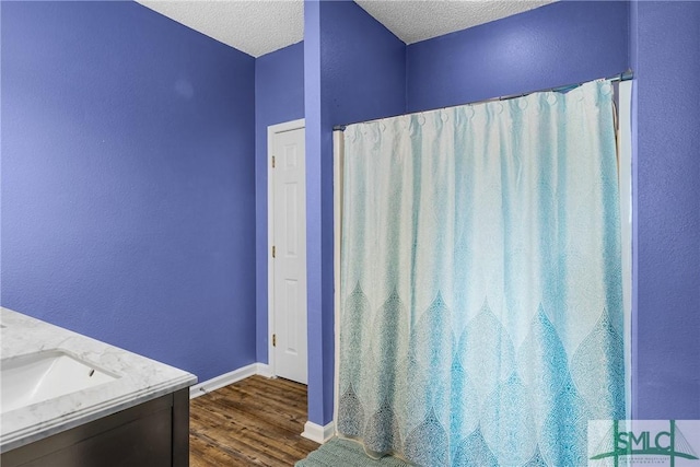 38 Travertine Cir, Savannah, GA 31419 - bathroom with wood finished floors, a textured ceiling, baseboards, vanity, and a shower with shower curtain