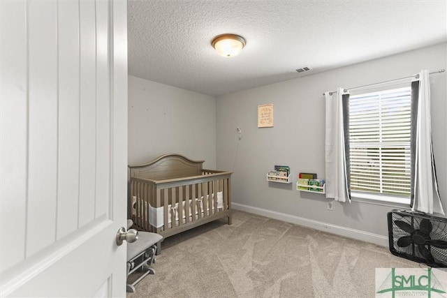 110 Richmond Pass Cir, Midway, GA 31320 - bedroom featuring multiple windows, carpet, a textured ceiling, baseboards, and a nursery area