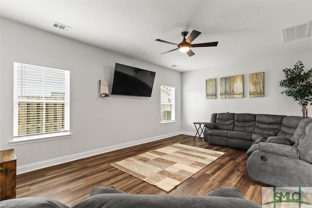110 Richmond Pass Cir, Midway, GA 31320 - living room featuring ceiling fan, wood finished floors, baseboards, and a textured ceiling
