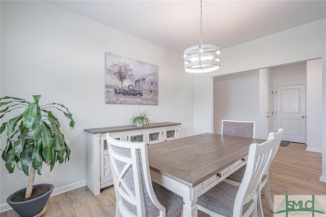 128 Greenbriar Dr, Guyton, GA 31312 - dining area with a chandelier, light wood-type flooring, and baseboards