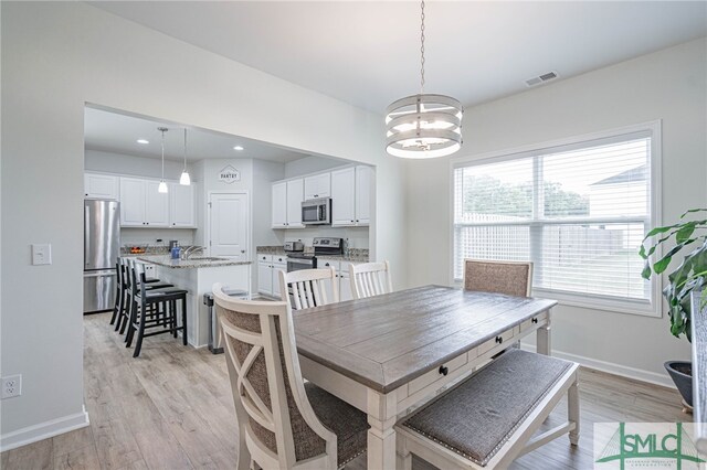 128 Greenbriar Dr, Guyton, GA 31312 - dining area with light wood finished floors, a chandelier, baseboards, and recessed lighting