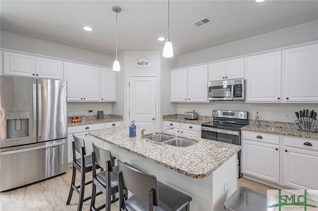128 Greenbriar Dr, Guyton, GA 31312 - kitchen with stainless steel appliances, a sink, white cabinets, and recessed lighting