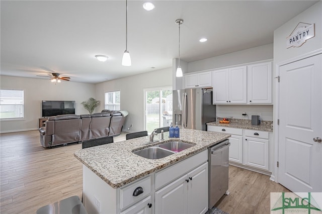 128 Greenbriar Dr, Guyton, GA 31312 - kitchen featuring stainless steel appliances, a sink, an island with sink, light wood-type flooring, and white cabinets