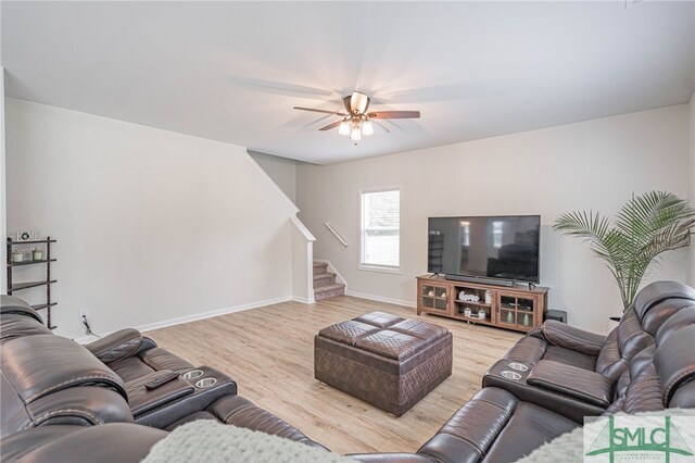 128 Greenbriar Dr, Guyton, GA 31312 - living area featuring stairway, wood finished floors, ceiling fan, and baseboards