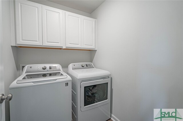 128 Greenbriar Dr, Guyton, GA 31312 - laundry room featuring cabinet space and washing machine and clothes dryer