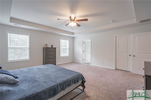 128 Greenbriar Dr, Guyton, GA 31312 - carpeted bedroom featuring a tray ceiling, baseboards, and ceiling fan