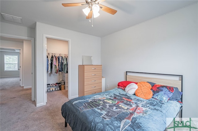 128 Greenbriar Dr, Guyton, GA 31312 - bedroom with carpet, a walk in closet, a closet, and a ceiling fan