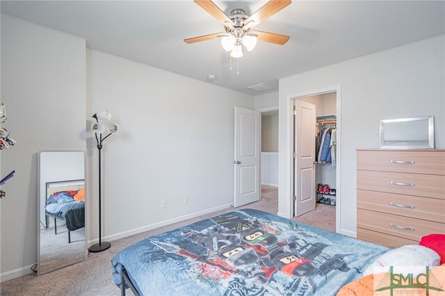 128 Greenbriar Dr, Guyton, GA 31312 - carpeted bedroom with baseboards, a walk in closet, and a ceiling fan