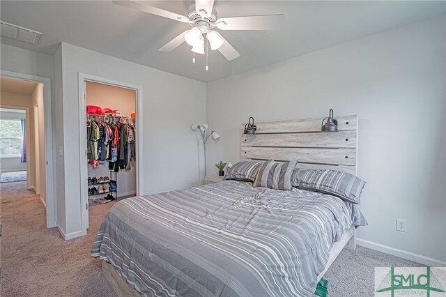 128 Greenbriar Dr, Guyton, GA 31312 - carpeted bedroom with baseboards, a walk in closet, ceiling fan, and a closet
