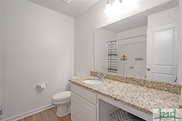 128 Greenbriar Dr, Guyton, GA 31312 - bathroom featuring wood finished floors, toilet, baseboards, vanity, and curtained shower