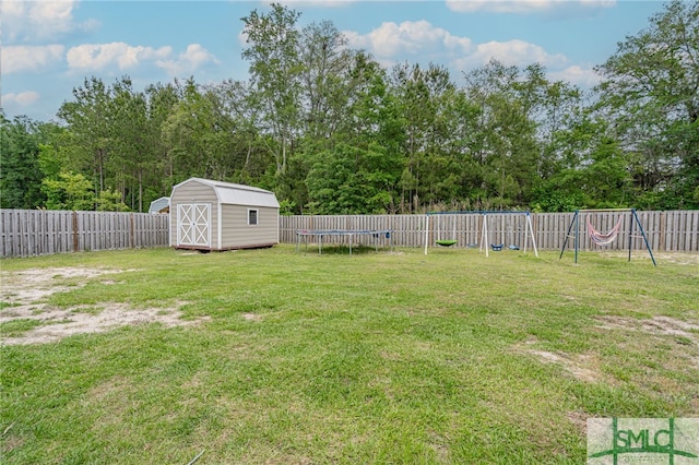 128 Greenbriar Dr, Guyton, GA 31312 - view of yard with a trampoline, a playground, a storage unit, and an outdoor structure