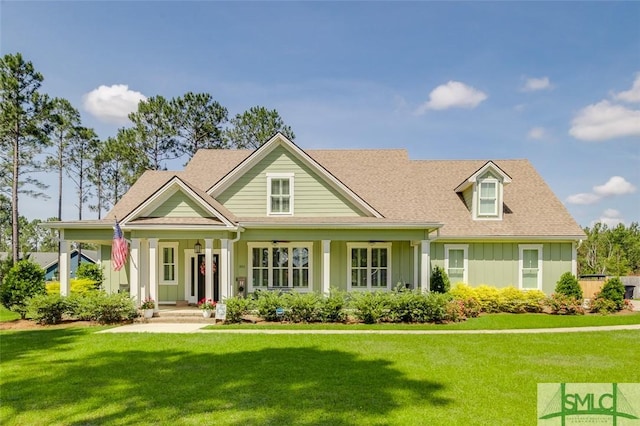201 Cumberland Pt, Statesboro, GA 30458 - view of front facade featuring board and batten siding, a front yard, a porch, and roof with shingles