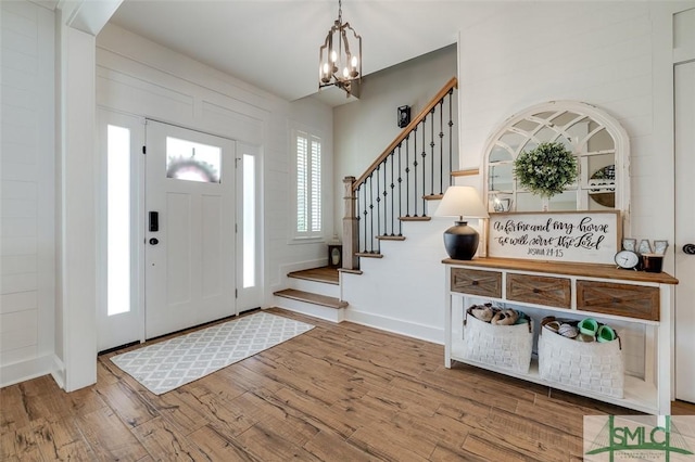 201 Cumberland Pt, Statesboro, GA 30458 - entryway featuring wood finished floors, a chandelier, baseboards, and stairs