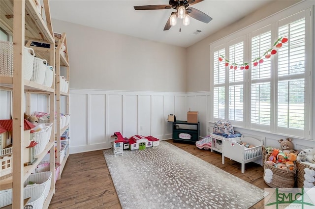 201 Cumberland Pt, Statesboro, GA 30458 - game room featuring wood finished floors, wainscoting, a decorative wall, and a ceiling fan