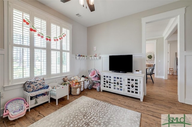 201 Cumberland Pt, Statesboro, GA 30458 - playroom with a ceiling fan, wood finished floors, a wainscoted wall, and a decorative wall
