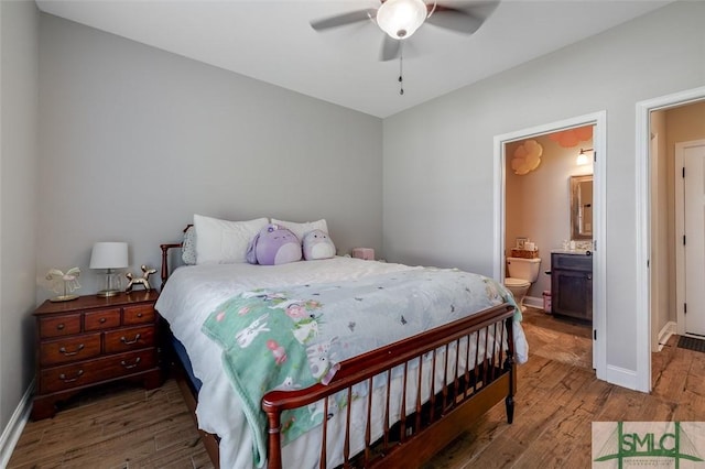 201 Cumberland Pt, Statesboro, GA 30458 - bedroom with wood finished floors, baseboards, ensuite bathroom, and ceiling fan