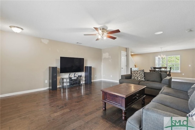 living room featuring a chandelier, ceiling fan, wood finished floors, and baseboards