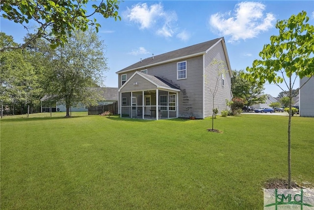 back of house with a sunroom and a yard