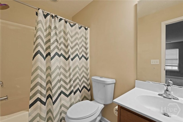 bathroom featuring toilet, vanity, and shower / tub combo with curtain