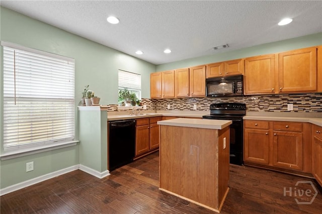 kitchen with black appliances, tasteful backsplash, light countertops, a textured ceiling, and recessed lighting