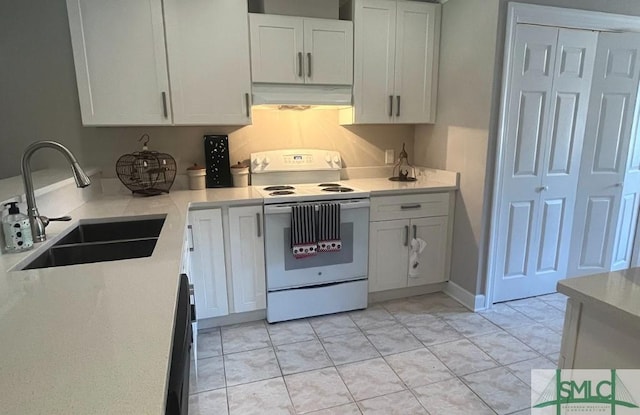 3005 River Dr Unit 401D, Savannah, GA 31404 - kitchen with electric range, a sink, under cabinet range hood, and light countertops