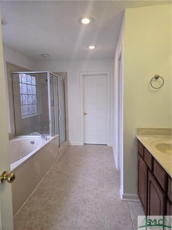 374 Stonebridge Cir, Savannah, GA 31419 - bathroom with a stall shower, vanity, a bath, tile patterned flooring, and baseboards