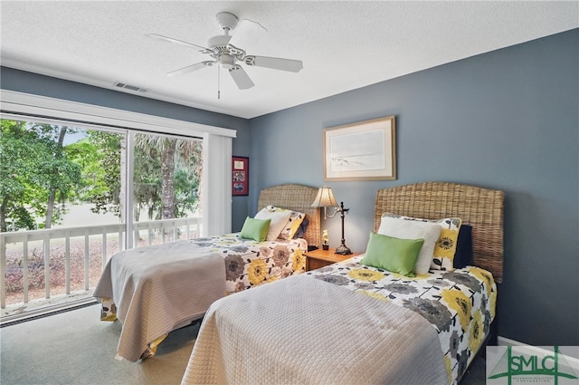 bedroom with carpet flooring, a ceiling fan, and a textured ceiling