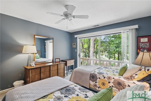 carpeted bedroom featuring access to exterior, baseboards, ceiling fan, and a textured ceiling