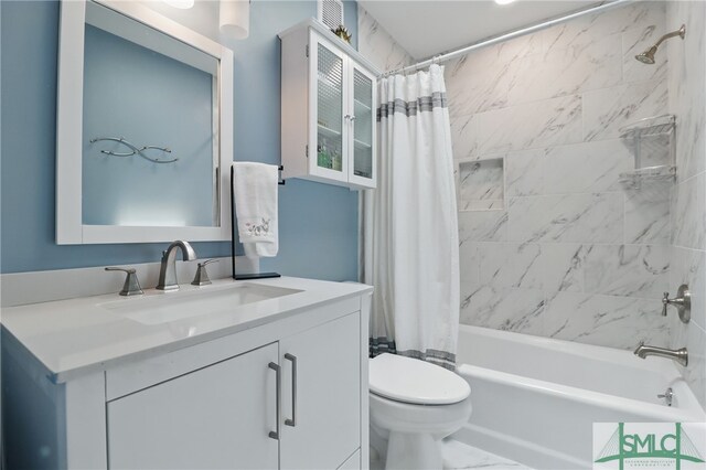 bathroom with shower / tub combo, toilet, vanity, and marble look tile flooring