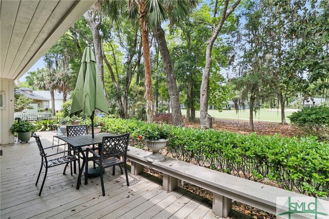 wooden terrace featuring outdoor dining area