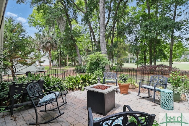 view of patio featuring fence and a fire pit