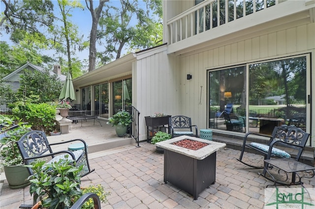view of patio / terrace featuring an outdoor fire pit