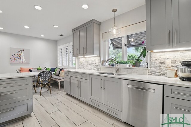 kitchen featuring dishwasher, gray cabinets, plenty of natural light, recessed lighting, and decorative backsplash