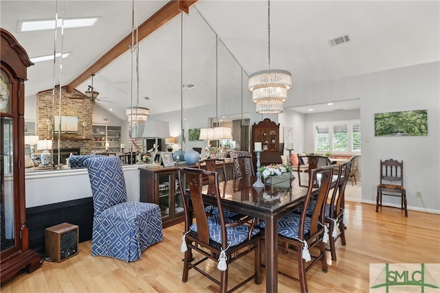 dining room with a chandelier, wood finished floors, a ceiling fan, and baseboards