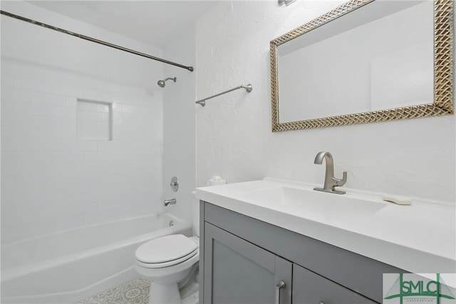 bathroom with toilet, vanity, a textured wall, and shower / bathtub combination