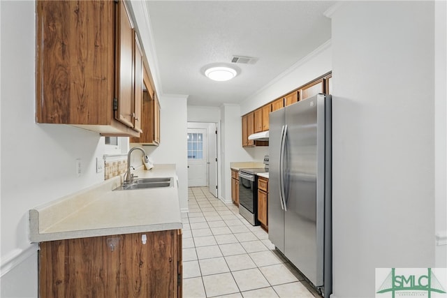 kitchen featuring stainless steel appliances, a sink, light countertops, brown cabinets, and crown molding