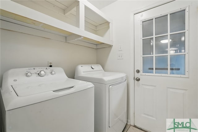 clothes washing area featuring separate washer and dryer