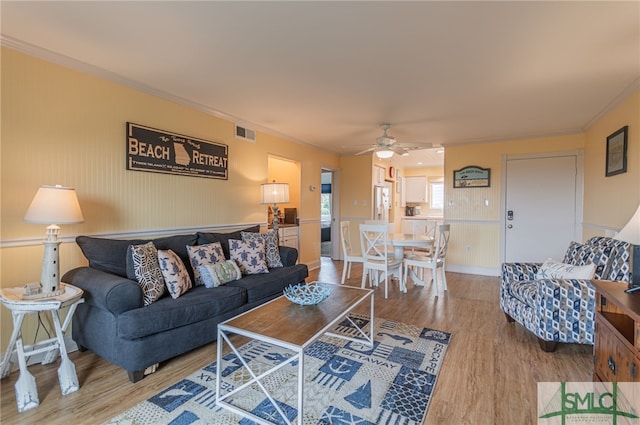 85 Van Horne Ave Unit 12A, Tybee Island, GA 31328 - living area with light wood-type flooring, ceiling fan, and crown molding