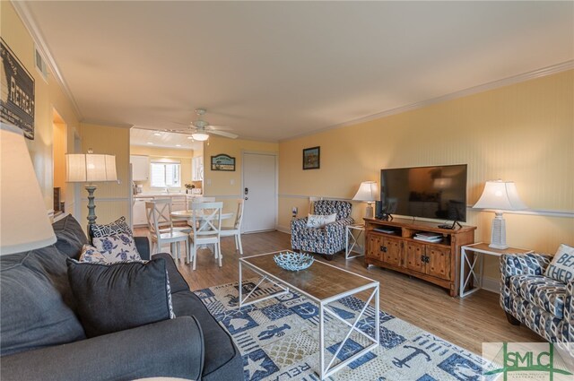 85 Van Horne Ave Unit 12A, Tybee Island, GA 31328 - living area with wood finished floors, a ceiling fan, and ornamental molding