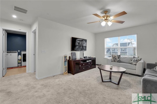 64 Southern Way, Richmond Hill, GA 31324 - carpeted living area featuring a ceiling fan, washing machine and dryer, and baseboards
