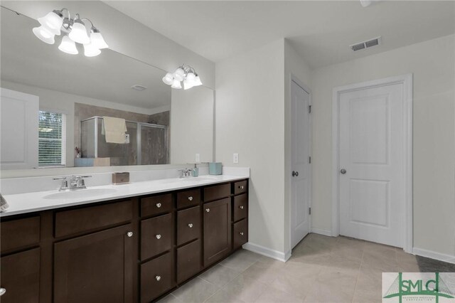 64 Southern Way, Richmond Hill, GA 31324 - bathroom featuring double vanity, a shower stall, a chandelier, tile patterned flooring, and baseboards