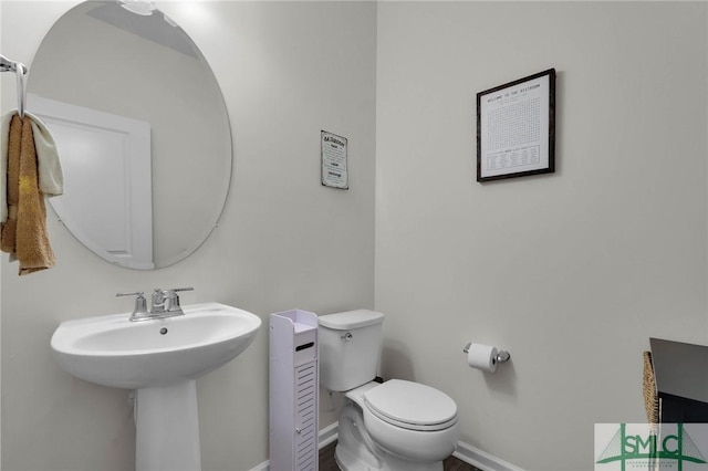 64 Southern Way, Richmond Hill, GA 31324 - bathroom featuring toilet, baseboards, and a sink