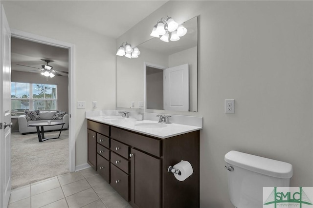 64 Southern Way, Richmond Hill, GA 31324 - full bath with tile patterned floors, double vanity, toilet, a ceiling fan, and baseboards