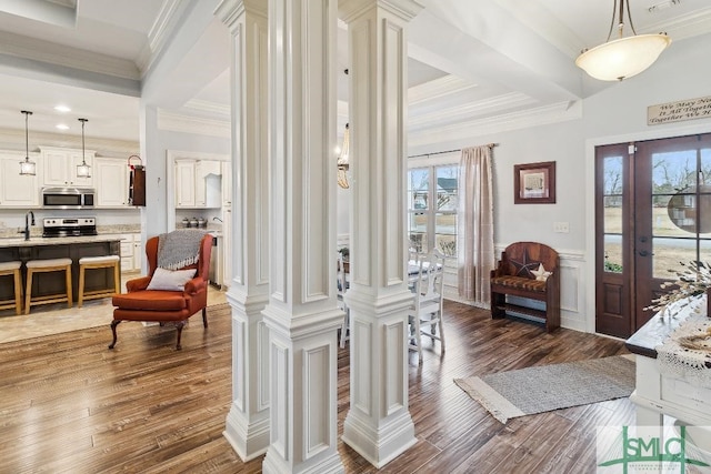 4 Honeysuckle Dr, Claxton, GA 30417 - entrance foyer featuring ornamental molding, dark wood-style floors, and decorative columns