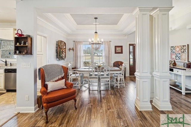 4 Honeysuckle Dr, Claxton, GA 30417 - dining room with decorative columns, hardwood / wood-style flooring, a tray ceiling, a chandelier, and crown molding