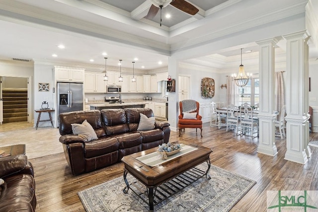 4 Honeysuckle Dr, Claxton, GA 30417 - living room with decorative columns, stairs, ceiling fan, a chandelier, and ornamental molding