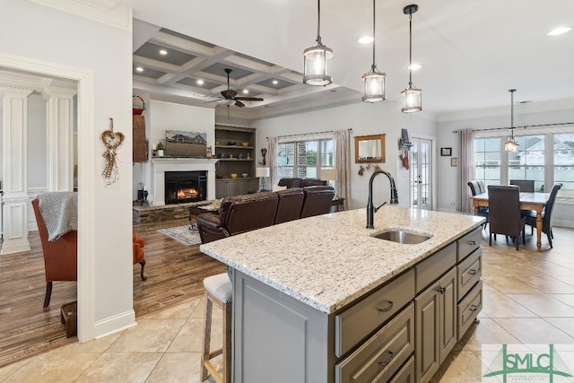 4 Honeysuckle Dr, Claxton, GA 30417 - kitchen featuring a ceiling fan, ornamental molding, a warm lit fireplace, light tile patterned floors, and gray cabinetry